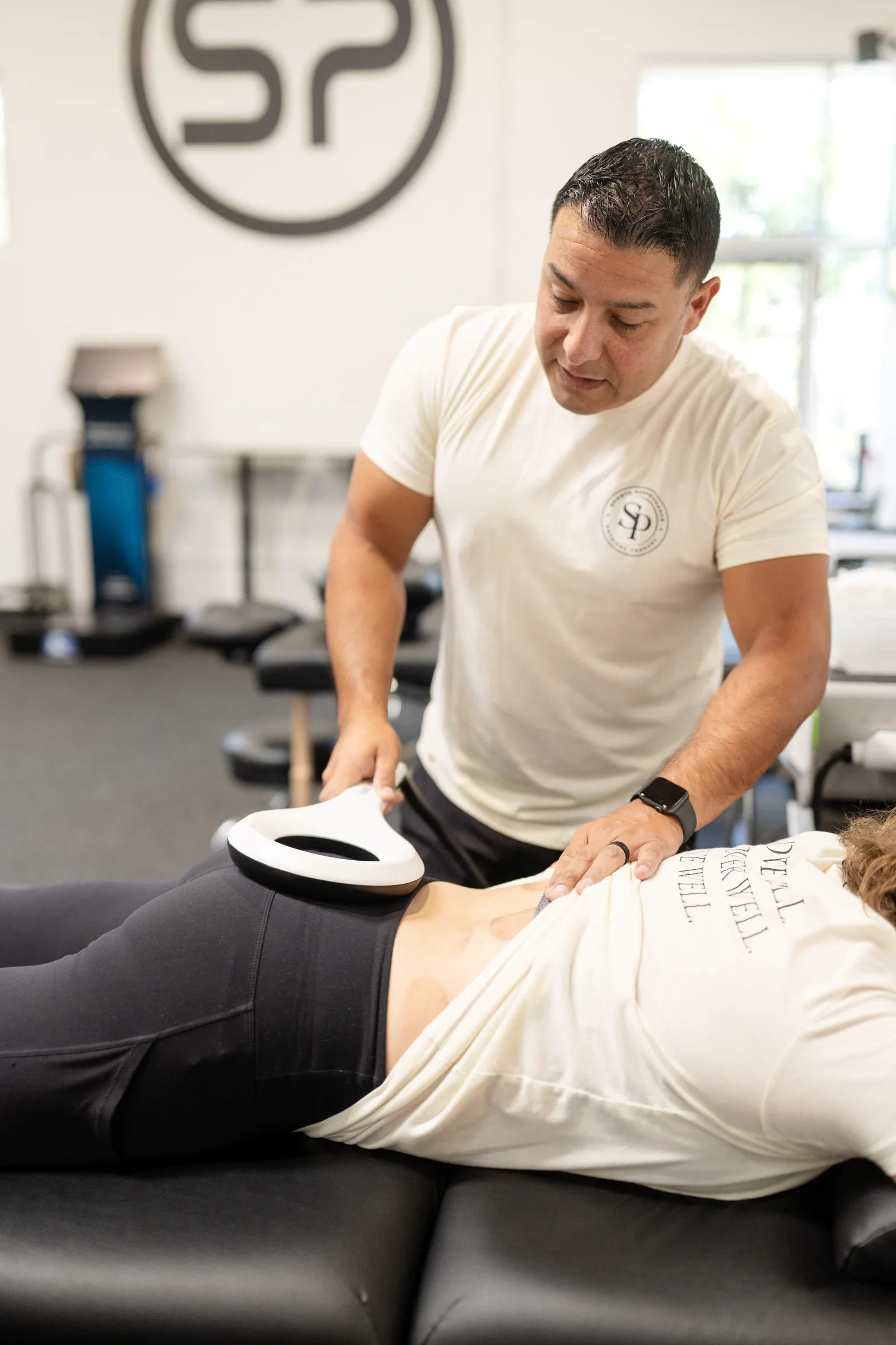 EMTT magnetotransduction applied to a client's lower back at Sports Performance in Chula Vista